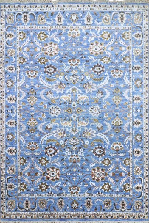 It is a Handknotted Oushak Carpet. The designs of Oushak have the characteristic of a soft colour palette, floral patterns and decorative borders. The sky-blue ground of the ivory and muted colouring is characteristic of this Oushak style.